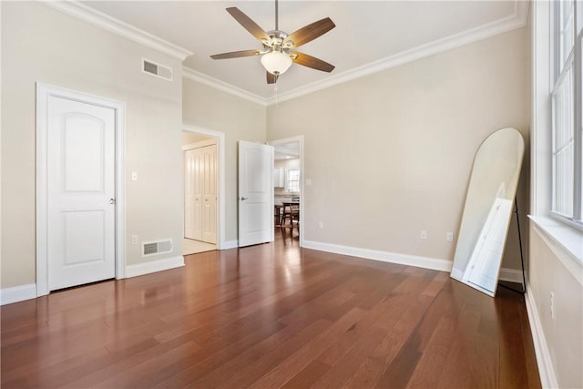 unfurnished bedroom with ceiling fan, ornamental molding, and dark hardwood / wood-style flooring