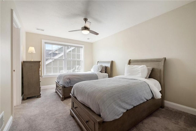 bedroom with ceiling fan and light carpet