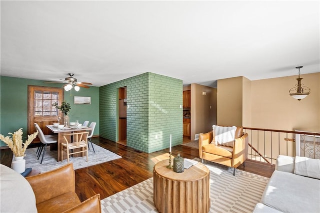 living room with wood-type flooring and ceiling fan