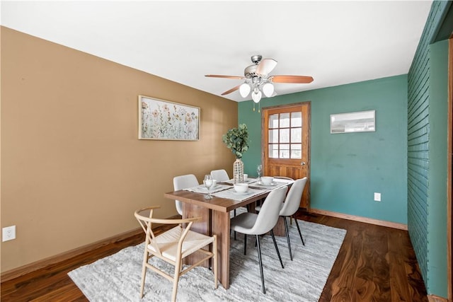 dining space with ceiling fan and dark hardwood / wood-style floors