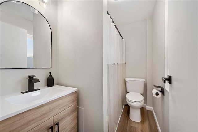 bathroom with vanity, hardwood / wood-style floors, and toilet