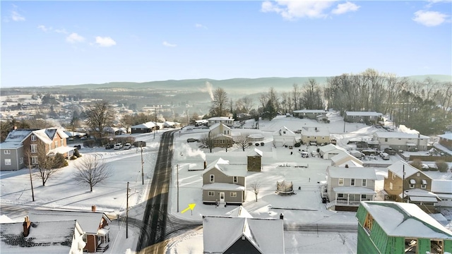 snowy aerial view with a mountain view