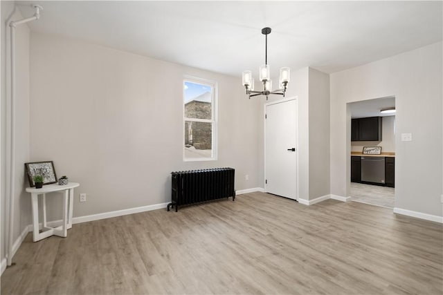 unfurnished dining area featuring radiator, a chandelier, and light hardwood / wood-style floors