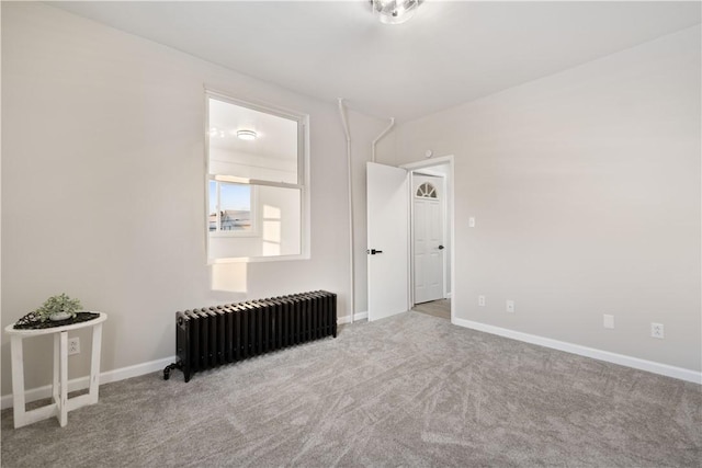 carpeted empty room with radiator heating unit