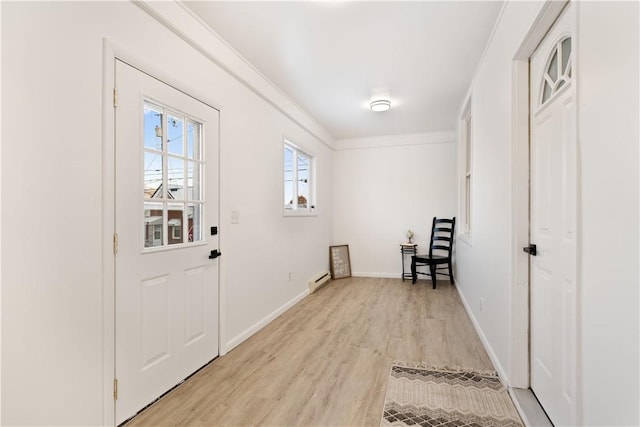 entryway with ornamental molding and light wood-type flooring