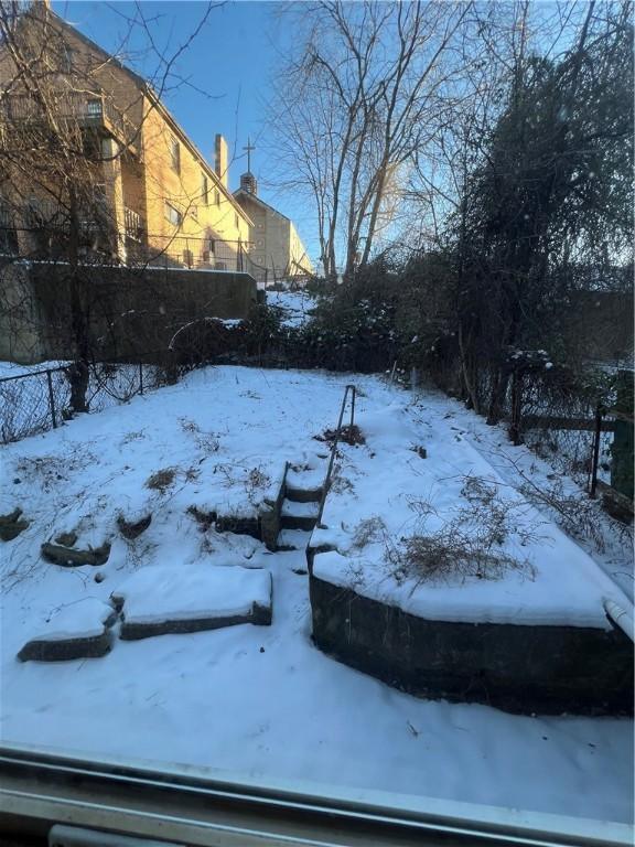 view of yard layered in snow