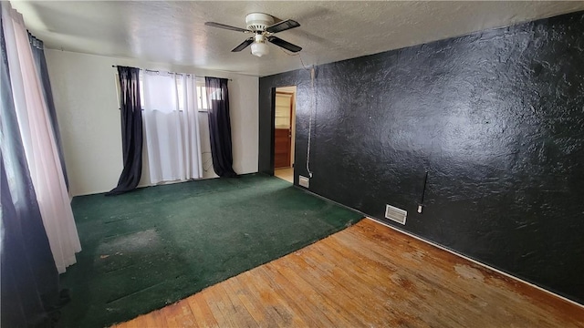 unfurnished room featuring hardwood / wood-style flooring, a textured ceiling, and ceiling fan