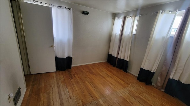 unfurnished bedroom featuring hardwood / wood-style flooring