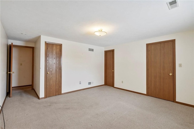 unfurnished bedroom featuring light colored carpet