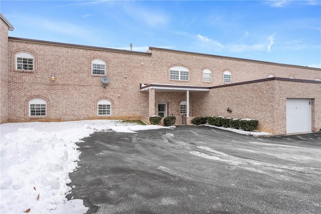 snow covered building with a garage