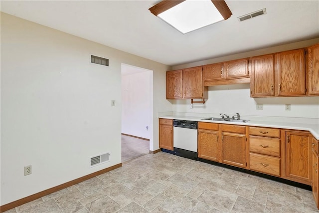 kitchen featuring dishwashing machine and sink