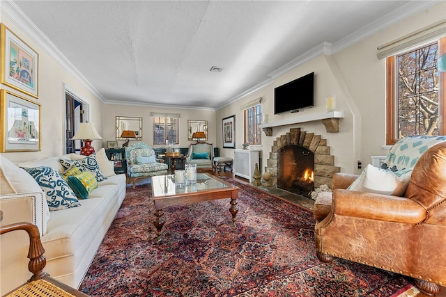 living room featuring a stone fireplace, a wealth of natural light, ornamental molding, and a textured ceiling