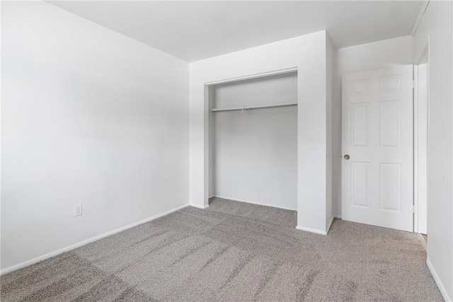 unfurnished bedroom featuring carpet and a closet