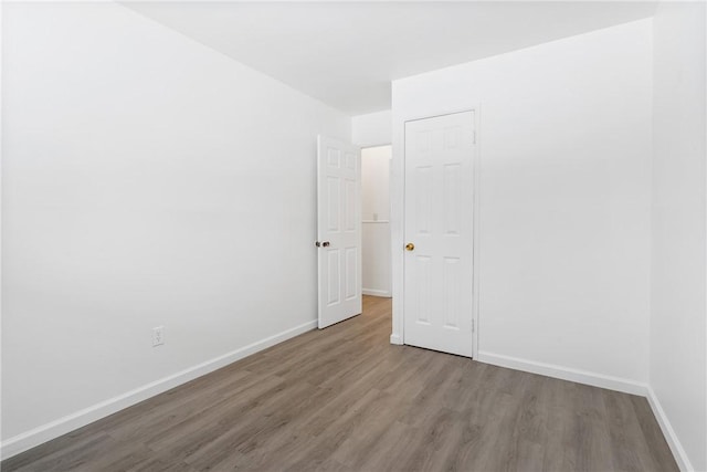 unfurnished bedroom with wood-type flooring