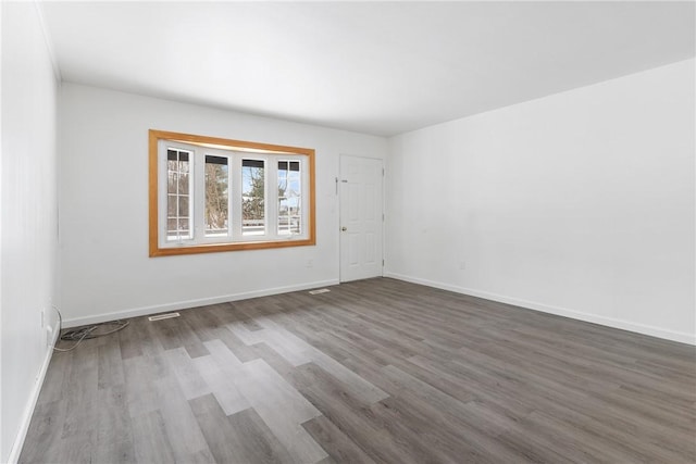 unfurnished room with dark hardwood / wood-style flooring