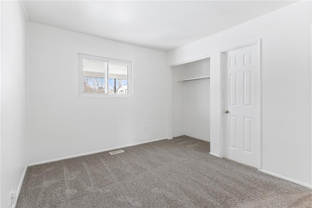 unfurnished bedroom featuring a closet and carpet