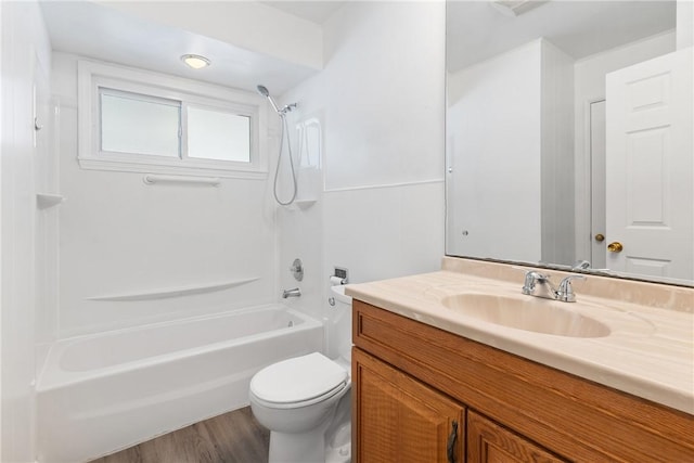 full bathroom with wood-type flooring, toilet, shower / washtub combination, and vanity