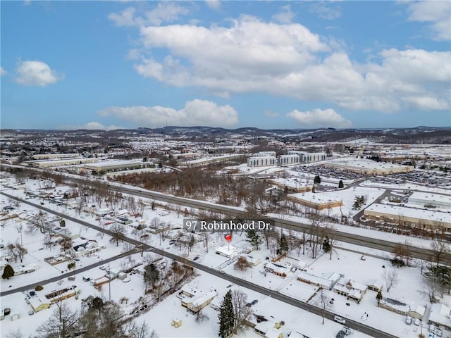 snowy aerial view featuring a mountain view