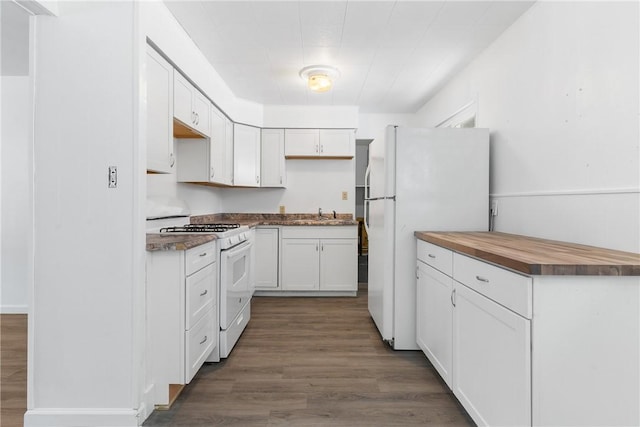 kitchen with white cabinetry, white appliances, butcher block countertops, and hardwood / wood-style floors