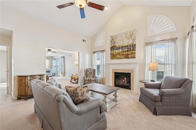 living room featuring light carpet, high vaulted ceiling, and ceiling fan