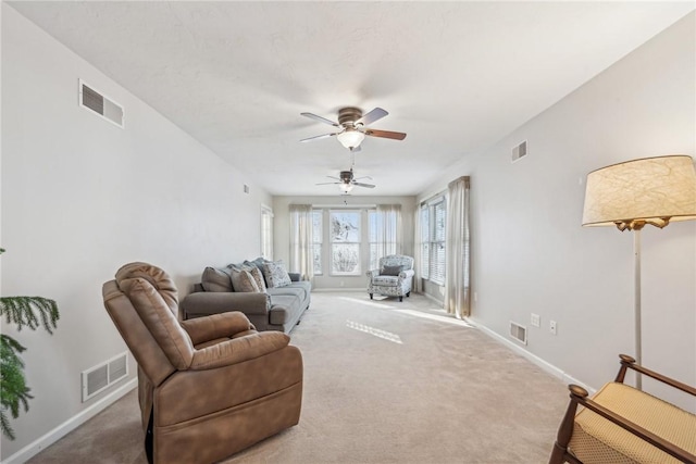 carpeted living room with ceiling fan