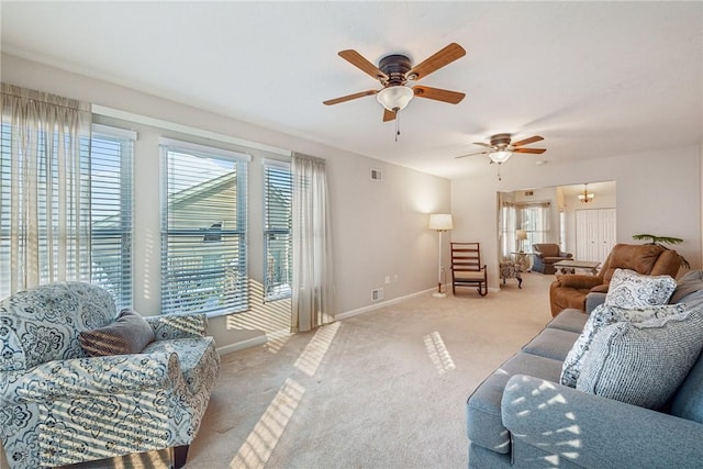 carpeted living room with ceiling fan