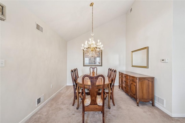 carpeted dining room featuring an inviting chandelier and lofted ceiling