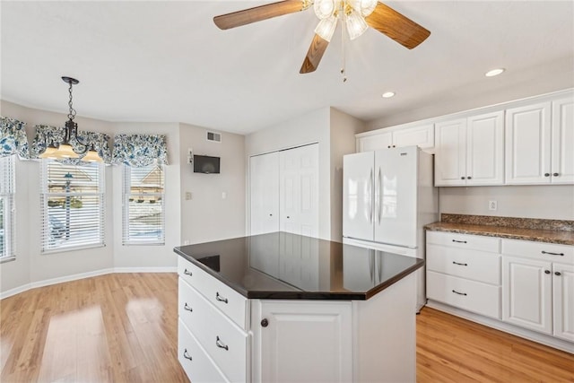 kitchen with light hardwood / wood-style flooring, a center island, white cabinets, decorative light fixtures, and white fridge