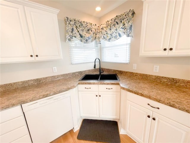 kitchen with sink, white cabinets, and dishwasher