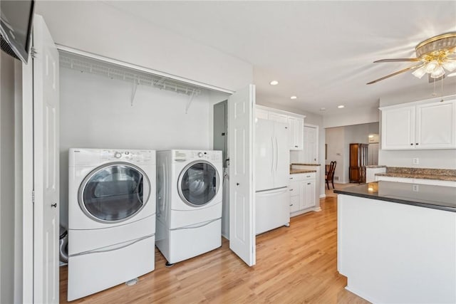 laundry room featuring separate washer and dryer, light hardwood / wood-style flooring, and ceiling fan