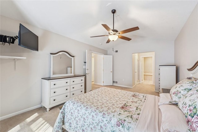 carpeted bedroom featuring lofted ceiling, connected bathroom, and ceiling fan