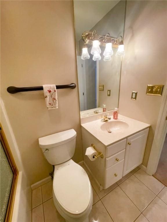 bathroom with vanity, a shower with shower door, tile patterned floors, and toilet