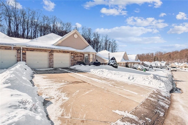 view of snowy exterior with a garage