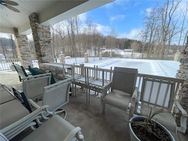 snow covered patio with ceiling fan