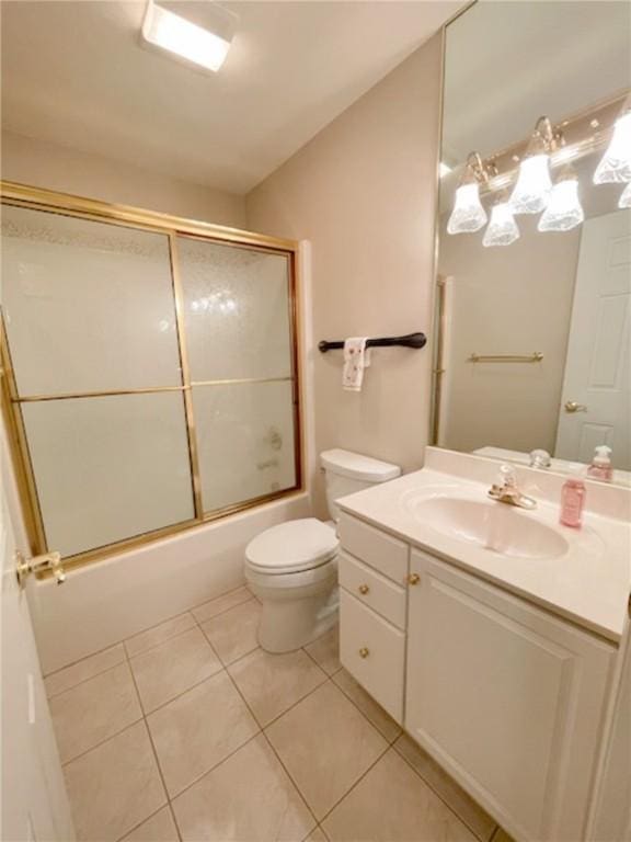 full bathroom featuring vanity, tile patterned floors, enclosed tub / shower combo, and toilet