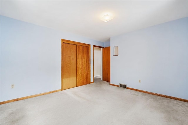 unfurnished bedroom with a closet and carpet flooring