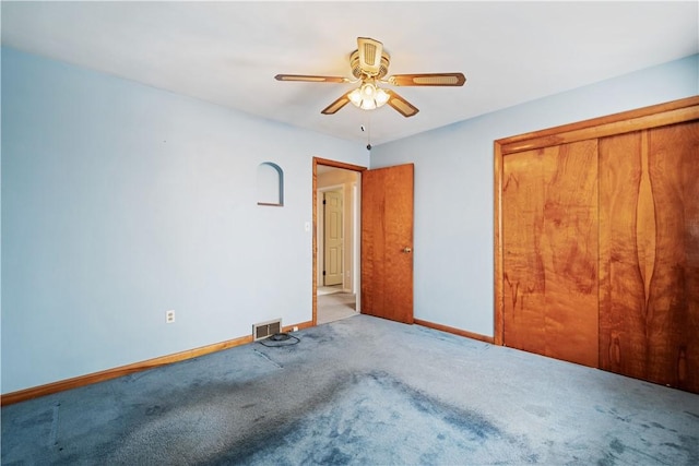 unfurnished bedroom featuring light carpet, ceiling fan, and a closet