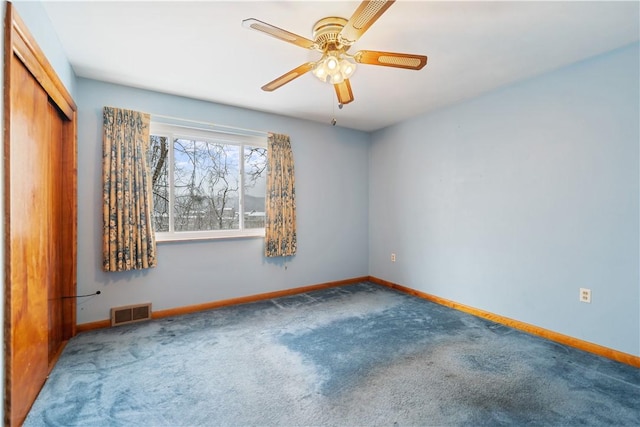 spare room featuring carpet and ceiling fan