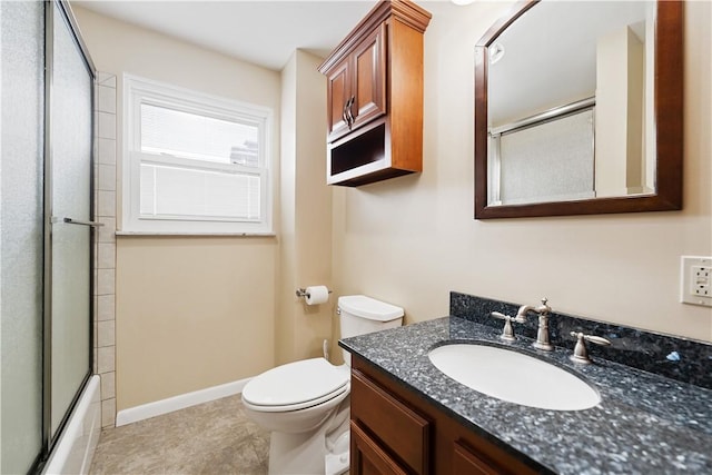 full bathroom featuring enclosed tub / shower combo, vanity, toilet, and tile patterned flooring