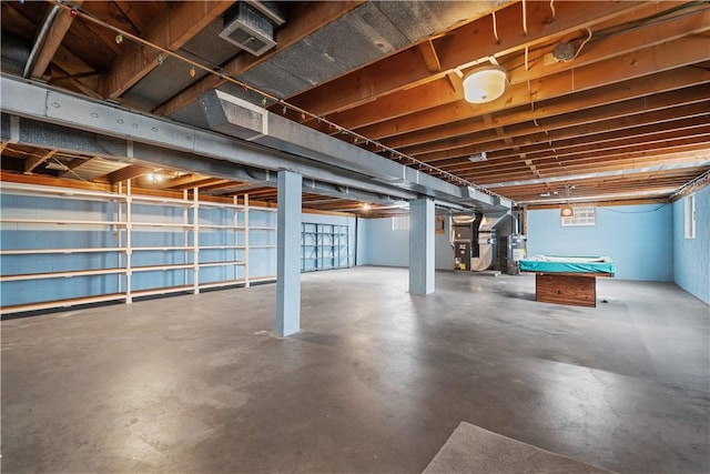 basement with heating unit and billiards