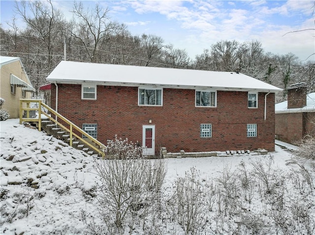 view of snow covered back of property