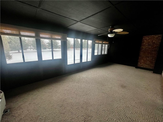 unfurnished sunroom with ceiling fan