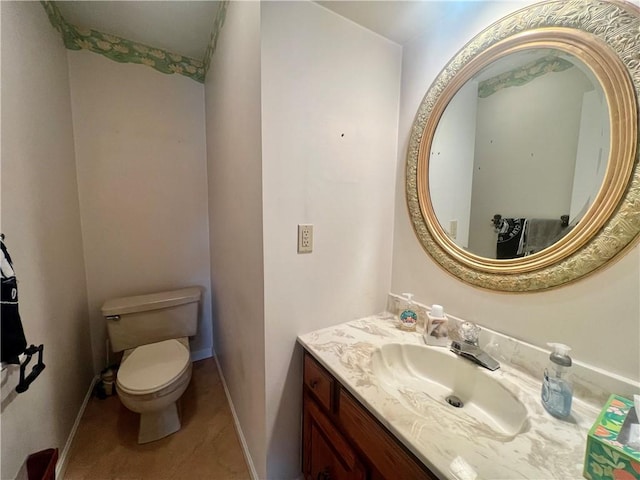 bathroom featuring tile patterned floors, vanity, and toilet