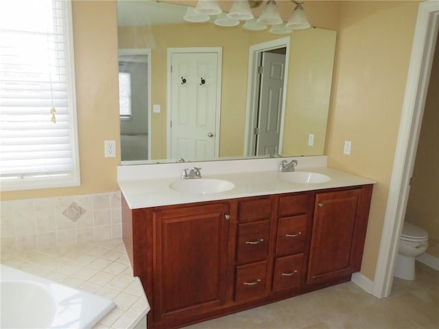 bathroom with vanity, plenty of natural light, and toilet