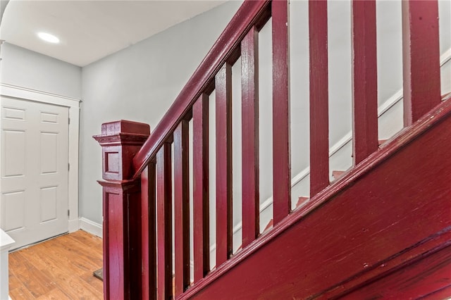 stairs featuring hardwood / wood-style flooring