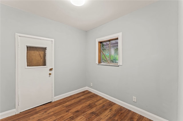 spare room featuring dark hardwood / wood-style flooring