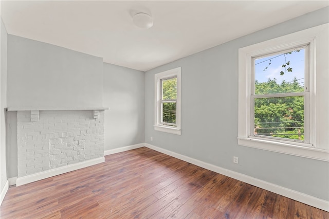 unfurnished living room featuring hardwood / wood-style flooring