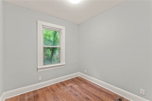 unfurnished room with hardwood / wood-style flooring