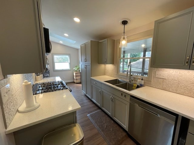 kitchen featuring gray cabinetry, sink, decorative light fixtures, and dishwasher