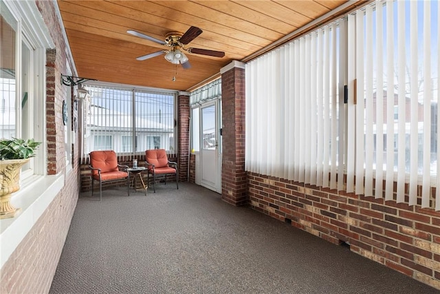 sunroom / solarium featuring ceiling fan and wooden ceiling